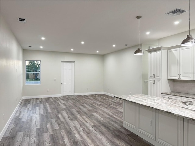 kitchen with visible vents, recessed lighting, white cabinetry, and wood finished floors