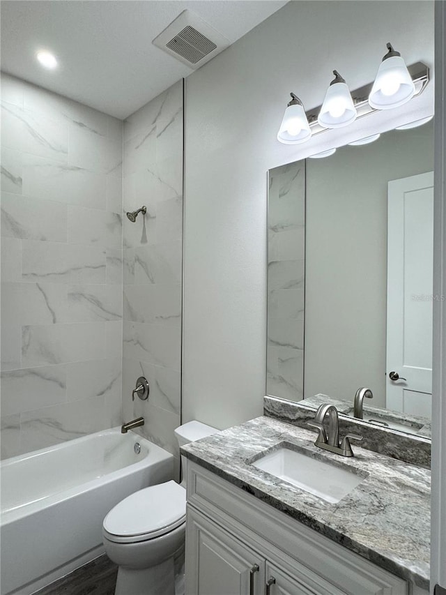 full bath featuring visible vents, vanity, toilet, and shower / tub combination