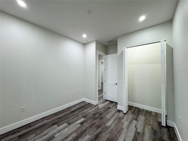 unfurnished bedroom featuring dark wood-style floors, visible vents, recessed lighting, and baseboards