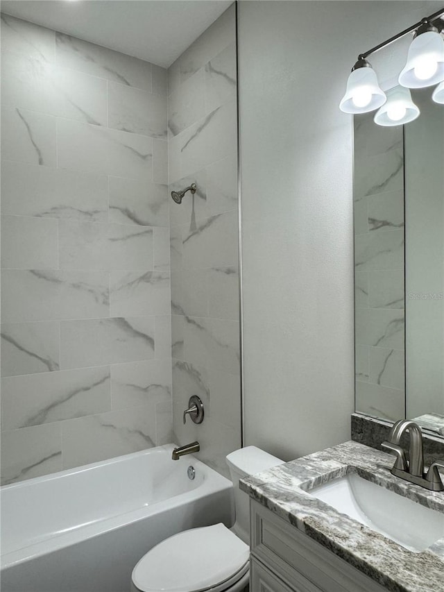 bathroom featuring toilet, vanity, and shower / tub combination