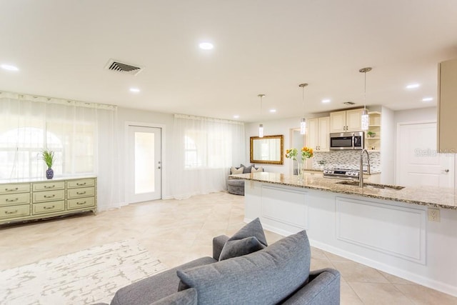 411 S Oxford Dr Unit 411, Nokomis, FL 34275 - kitchen featuring light stone counters, visible vents, open shelves, a sink, and appliances with stainless steel finishes