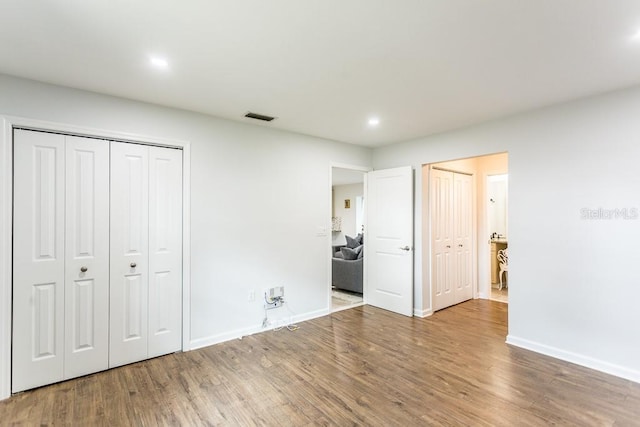 411 S Oxford Dr Unit 411, Nokomis, FL 34275 - unfurnished bedroom featuring visible vents, baseboards, and wood finished floors