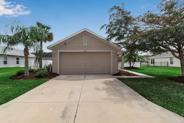 garage featuring driveway and fence