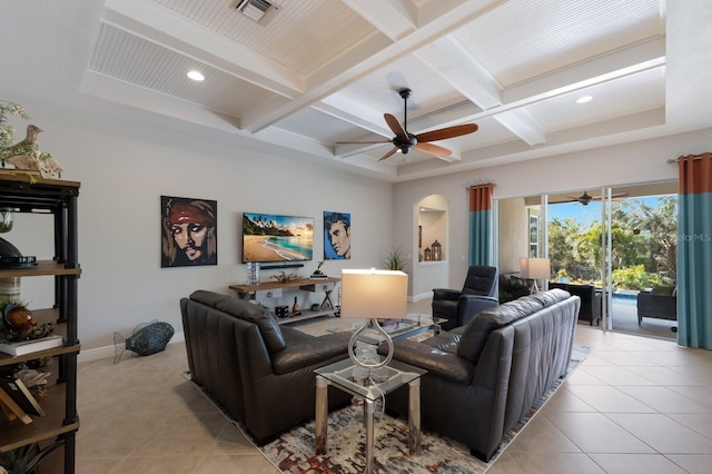 living room featuring arched walkways, visible vents, a ceiling fan, and light tile patterned floors