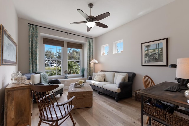 living room featuring a ceiling fan and light wood finished floors