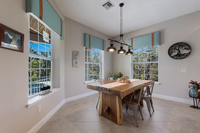 dining area with a wealth of natural light, visible vents, and baseboards