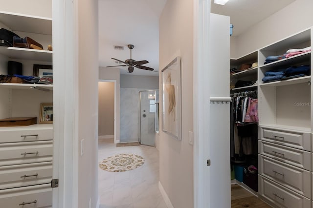 walk in closet featuring visible vents and ceiling fan