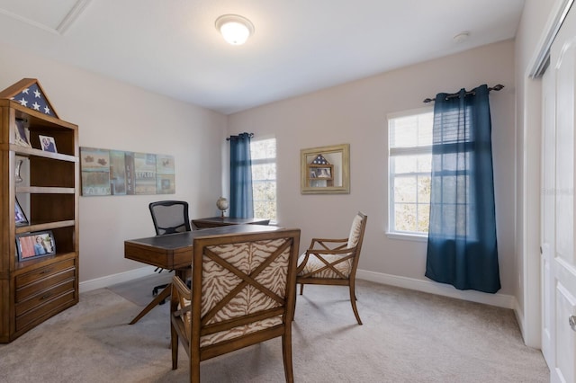 home office with baseboards, light colored carpet, and a healthy amount of sunlight