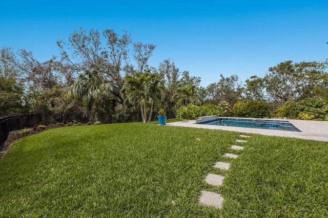 view of yard with a fenced in pool and fence