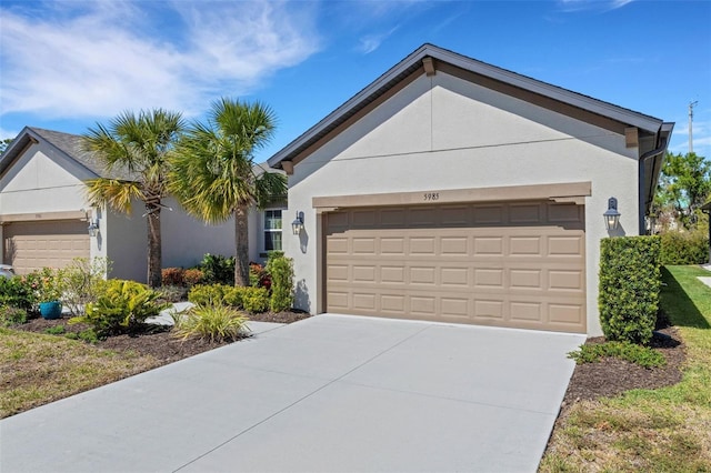 ranch-style house featuring stucco siding, driveway, and a garage