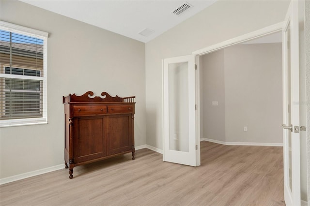 unfurnished room with visible vents, baseboards, and light wood-style floors