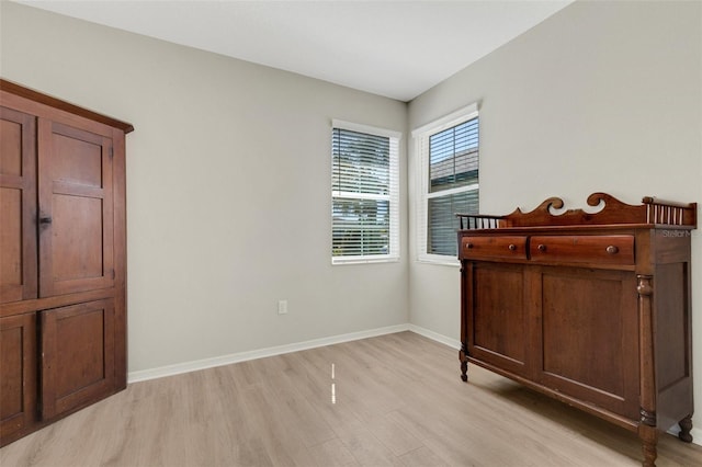 unfurnished bedroom featuring baseboards and light wood finished floors