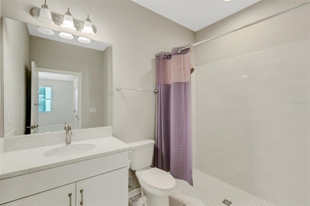 bathroom with vanity, a shower stall, and toilet