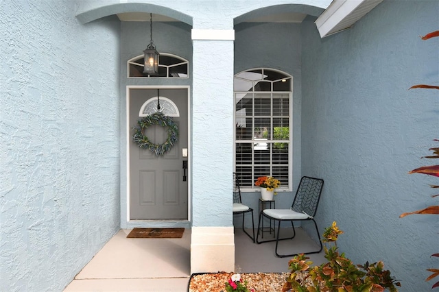 doorway to property with stucco siding