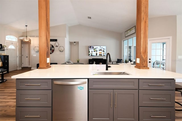 kitchen with a sink, gray cabinets, open floor plan, and stainless steel dishwasher