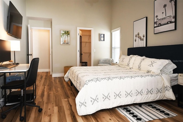 bedroom with baseboards and dark wood-style flooring