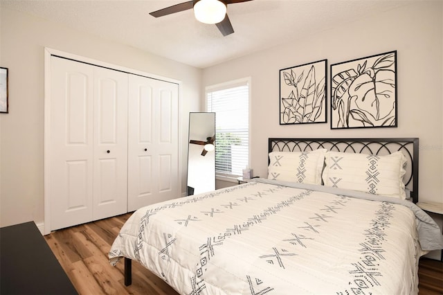 bedroom featuring a ceiling fan, wood finished floors, a closet, and a textured ceiling