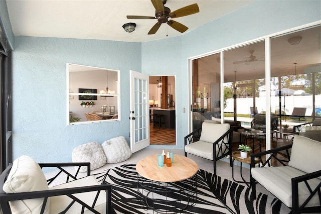 sunroom featuring a ceiling fan