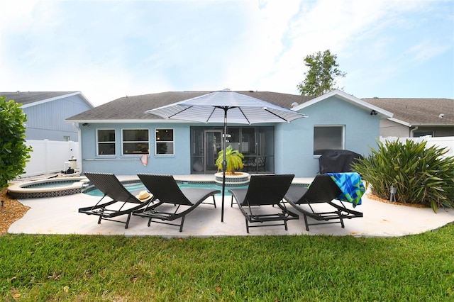 back of house with stucco siding, a fenced in pool, an in ground hot tub, and a patio area