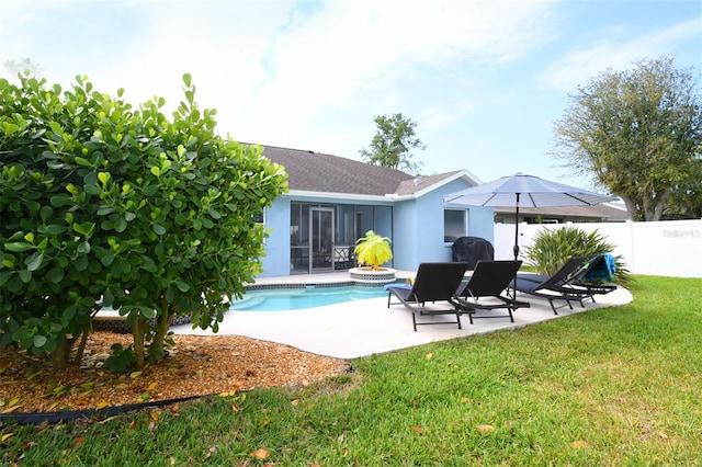 back of property featuring a fenced in pool, fence, stucco siding, a patio area, and a lawn