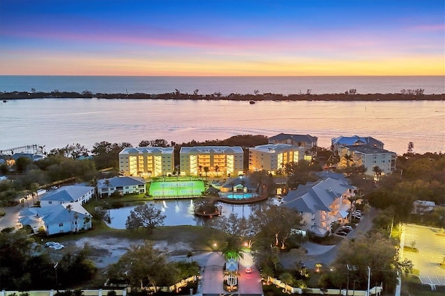 aerial view at dusk with a water view