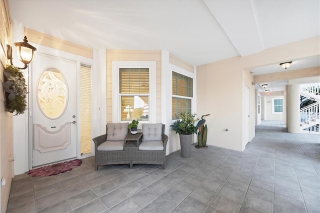 view of exterior entry featuring covered porch and stucco siding