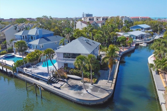 birds eye view of property featuring a water view and a residential view