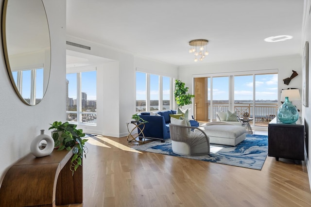 35 Watergate Dr Unit 1402, Sarasota, FL 34236 - living room with a chandelier, plenty of natural light, and wood finished floors