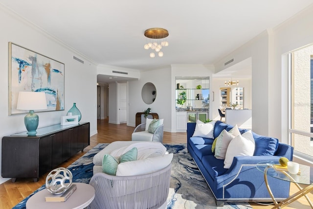 35 Watergate Dr Unit 1402, Sarasota, FL 34236 - living room featuring a notable chandelier, crown molding, visible vents, and wood finished floors