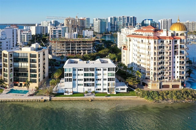 birds eye view of property featuring a view of city and a water view