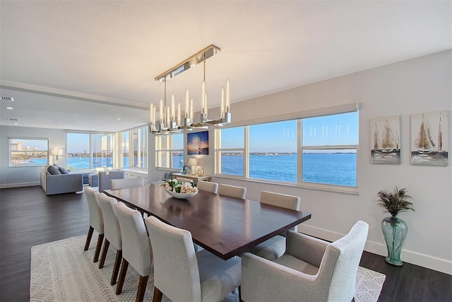 dining area featuring visible vents, baseboards, an inviting chandelier, and dark wood-style flooring