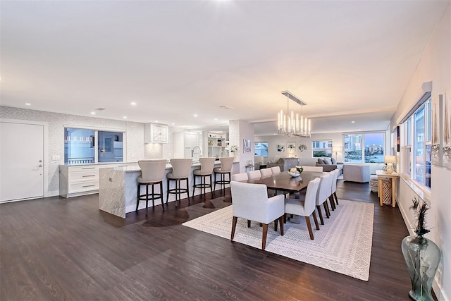 dining area featuring recessed lighting, dark wood-style floors, and a chandelier