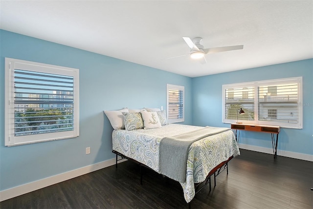 bedroom featuring a ceiling fan, baseboards, and wood finished floors