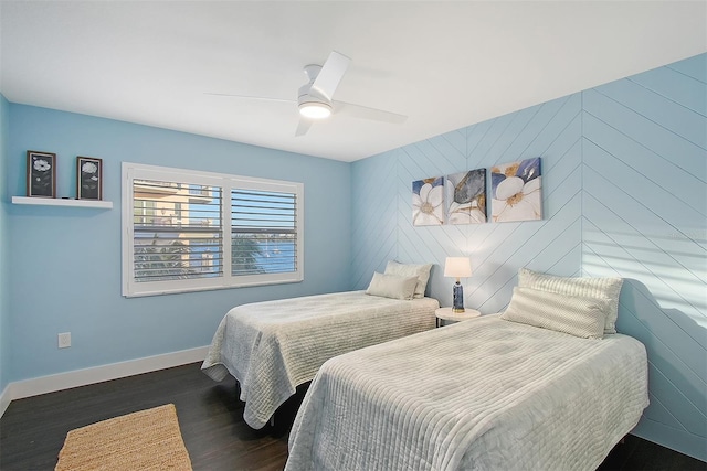 bedroom featuring wood finished floors, baseboards, and ceiling fan