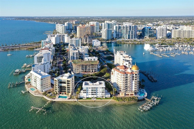 birds eye view of property with a view of city and a water view