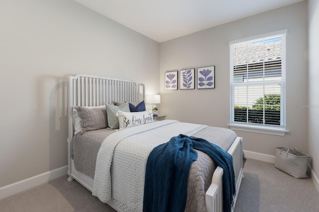 carpeted bedroom featuring baseboards