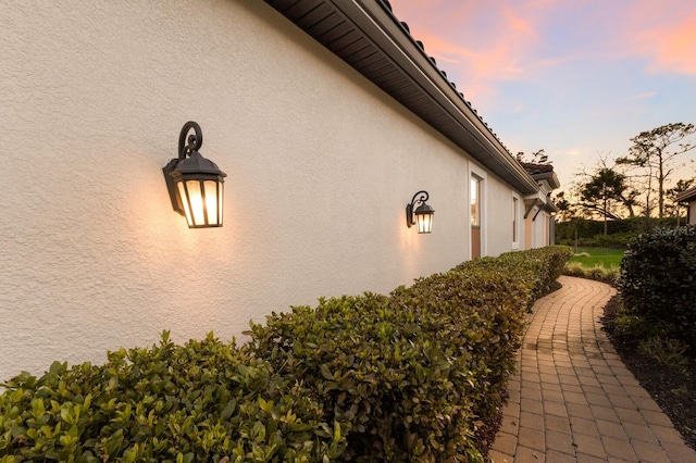 view of side of property with stucco siding