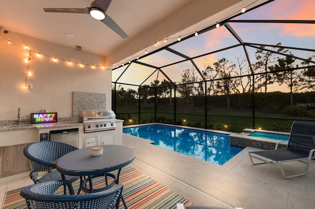 pool at dusk with a patio, area for grilling, a sink, a lanai, and a grill