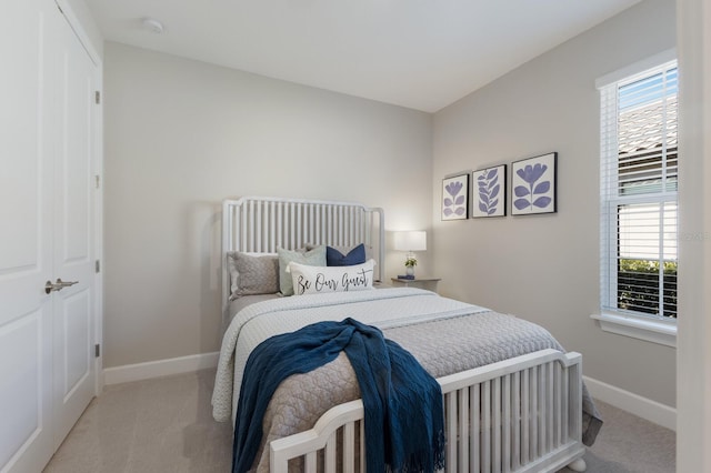 carpeted bedroom with baseboards