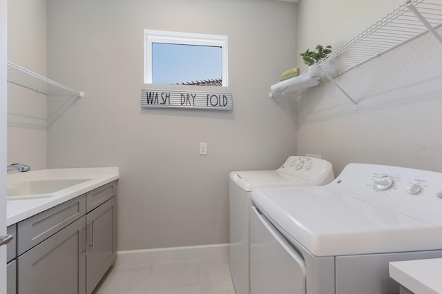 laundry room with independent washer and dryer, a sink, cabinet space, light tile patterned floors, and baseboards