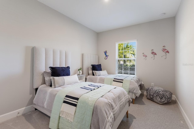 carpeted bedroom featuring baseboards