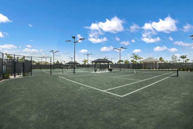 view of tennis court with fence