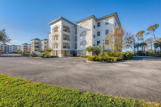 view of building exterior featuring uncovered parking