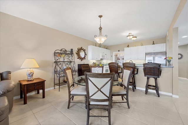 dining room featuring light tile patterned floors and baseboards