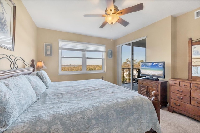 bedroom featuring access to exterior, carpet flooring, a ceiling fan, and visible vents