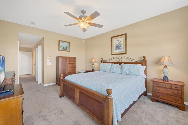 bedroom with baseboards, light carpet, and a ceiling fan