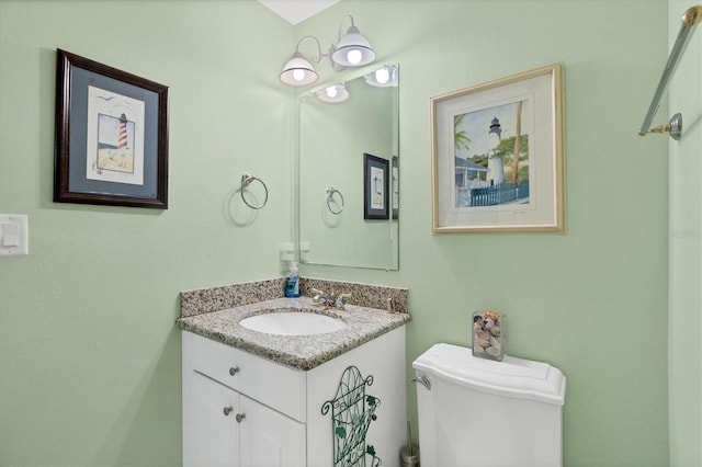 bathroom with toilet and vanity