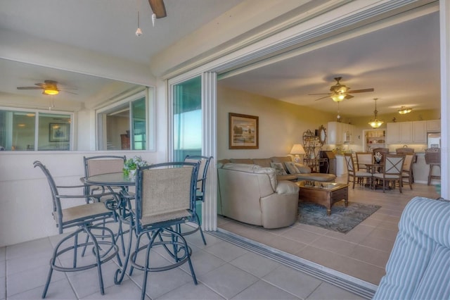 exterior space featuring a ceiling fan and tile patterned flooring