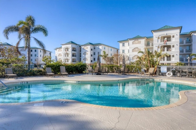 view of pool with a patio and fence