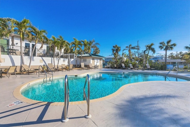 pool featuring a patio area and fence